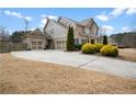 Spacious driveway leading to a two-car garage with an attractive exterior and mature landscaping at 4535 Meadow Green Ln, Acworth, GA 30101