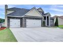 View of the attractive facade and large driveway of this handsome two story home at 6793 Oconee Pl, Fairburn, GA 30213