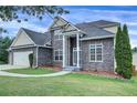 View of the attractive facade and landscaping of this handsome two story home at 6793 Oconee Pl, Fairburn, GA 30213