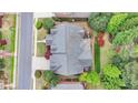 Aerial view of home showcasing the roofline, deck, manicured landscaping, and mature trees at 8070 Georgetown Cir, Suwanee, GA 30024