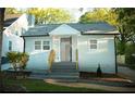 Cozy home featuring a light blue exterior, well-maintained lawn, and inviting entryway at 2022 Detroit Ave, Atlanta, GA 30314