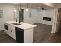 Modern kitchen opens to a living room featuring a fireplace and hardwood floors at 2022 Detroit Ave, Atlanta, GA 30314