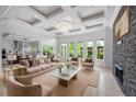 Open concept living space with an elegant living room with a fireplace and a modern kitchen at 5395 Lacosta Ln, Alpharetta, GA 30022
