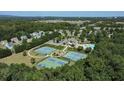 Community aerial view showcasing tennis courts, a pool, and beautiful green spaces, perfect for active living at 5510 Weddington Dr, Cumming, GA 30040