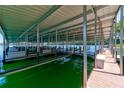 Covered boat dock with multiple slips in green water on a sunny day at 00 Pebble Rock Dr, Cumming, GA 30041