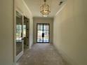 Grand foyer with black metal entry door, chandelier, and open layout at 00 Pebble Rock Dr, Cumming, GA 30041