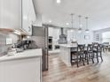 Bright kitchen with stainless steel appliances, large island with seating and modern pendant lighting at 449 Carmichael Cir, Canton, GA 30115