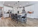 Spacious kitchen features white cabinets, stainless steel appliances, and a large island with seating for four at 449 Carmichael Cir, Canton, GA 30115