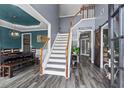 Bright foyer with staircase, wood floors, and view into the dining room at 904 Beaumont Ct, Canton, GA 30114