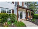 Inviting front porch with wood columns and hanging plants at 904 Beaumont Ct, Canton, GA 30114