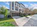 Attractive townhome with a brick and white exterior, two-car garage, and well-maintained landscaping at 1388 La France Ne St, Atlanta, GA 30307