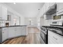 Bright kitchen with white cabinets, stainless steel appliances, and breakfast bar at 488 Takely Dr, Lawrenceville, GA 30046