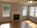 Bright and airy living room features hardwood floors, large windows, and a fireplace at 5815 Mountain Top Pl, Cumming, GA 30041