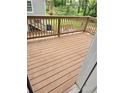 Spacious wooden deck with railing, perfect for outdoor entertaining and enjoying the surrounding landscape at 1427 Lorenzo Sw Dr, Atlanta, GA 30310