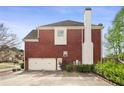 Spacious two-car garage and lengthy driveway on a well-maintained brick home at 295 Langshire Dr, Mcdonough, GA 30253