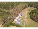 Expansive aerial view highlighting home and outbuildings nestled in a wooded landscape at 111 Ayers Driver Rd, Villa Rica, GA 30180