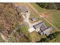 Expansive aerial view of the property showing the layout of the buildings, land, and surrounding trees at 111 Ayers Driver Rd, Villa Rica, GA 30180