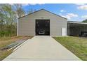 Spacious outbuilding with a wide door and ample space for vehicle storage at 111 Ayers Driver Rd, Villa Rica, GA 30180