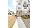 Attractive three-story townhouse with brick accents and a manicured front lawn at 1166 Farmstead Rd, Suwanee, GA 30024