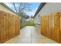 Long driveway enclosed by wood fences, providing backyard privacy and ample parking space at 1716 Browning Sw St, Atlanta, GA 30314