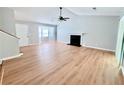 Sunlit living room with a fireplace, hardwood floors, and bay window at 440 Sheppard Xing Ct, Stone Mountain, GA 30083