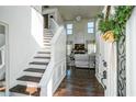 Bright entryway with hardwood floors, staircase and entry to the living room with soaring ceilings at 1240 Birchwood Ln, Roswell, GA 30076