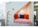 Under-stairs reading nook with plush cushions and unique design elements create a cozy and inviting space at 1240 Birchwood Ln, Roswell, GA 30076