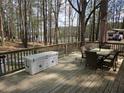 Large back deck overlooking a picturesque lake surrounded by mature trees, perfect for relaxing outdoors at 5440 Portside Dr, Acworth, GA 30101