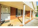 Inviting front porch with brick columns and black shuttered windows at 2972 Ponderosa Cir, Decatur, GA 30033