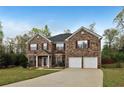 Classic brick home with a two-car garage, traditional shutters, and a lovely front lawn at 159 Molly Way, Mcdonough, GA 30253