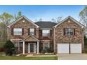 Beautiful two-story brick home featuring a classic design and well-maintained landscaping at 159 Molly Way, Mcdonough, GA 30253