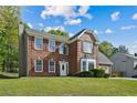 Two-story brick home with a well-manicured lawn, red shutters, and a chimney at 3937 Sautee Trl, Conley, GA 30288