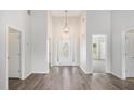 Bright entryway with high ceilings, chandelier, and decorative glass front door at 609 Alyssa Ct, Locust Grove, GA 30248