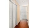 Hallway featuring wood-look floors, a closet, and decorative glass block accent at 2161 Peachtree Ne Rd # 402, Atlanta, GA 30309