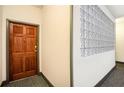 Hallway featuring a wood door and decorative glass block accent at 2161 Peachtree Ne Rd # 402, Atlanta, GA 30309