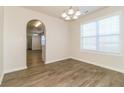 Dining area with modern lighting, hardwood floors, and large windows creating a bright and inviting atmosphere at 4437 James Wade Dr, Snellville, GA 30039