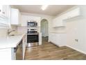 Bright kitchen featuring stainless steel appliances, sleek countertops, and white cabinets for a modern touch at 4437 James Wade Dr, Snellville, GA 30039