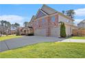 Well-maintained two-story brick home with an attached two-car garage and large driveway at 4922 Summer Wind Dr, Buford, GA 30519