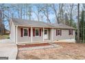 Inviting single-story home boasting vinyl siding, a covered porch, and stone landscaping accents at 5700 Tracy Dr, Mableton, GA 30126