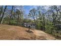 Scenic view of a two-story home with an attached garage and a long driveway at 1504 Kimberly Pl, Canton, GA 30114