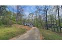 A scenic view of a two-story home surrounded by lush greenery and tall trees at 1504 Kimberly Pl, Canton, GA 30114