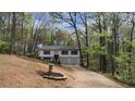 Scenic view of a two-story home with an attached garage, surrounded by lush trees at 1504 Kimberly Pl, Canton, GA 30114