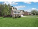 Spacious lawn showcasing house with neutral siding, well-kept garden, and a long driveway at 3380 Duncan Bridge Dr, Buford, GA 30519