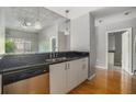 Open kitchen with stainless steel dishwasher and black countertops at 250 Pharr Ne Rd # 405, Atlanta, GA 30305