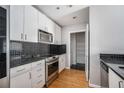 Galley kitchen with stainless steel appliances and black backsplash at 250 Pharr Ne Rd # 405, Atlanta, GA 30305