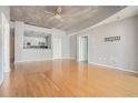 Open-concept living area with hardwood floors and kitchen view at 250 Pharr Ne Rd # 405, Atlanta, GA 30305