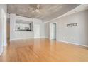 Open living room with hardwood floors showcasing the pass-through to the kitchen at 250 Pharr Ne Rd, Atlanta, GA 30305