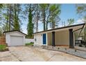 A carport is attached to the house near the detached garage at 307 Gordon Woods Sw Dr, Mableton, GA 30126