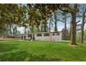 Ranch home with lush green lawn and mature shade trees at 307 Gordon Woods Sw Dr, Mableton, GA 30126