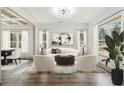 Inviting living room featuring a modern sofa, accent chairs, and large windows with natural light at 400 Stone Lea Trce, Oxford, GA 30054